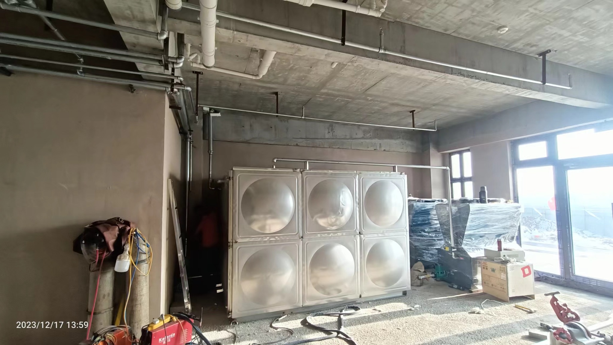 Insulated water tank and pipework in the Wucaiwan hotel equipment room